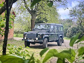 Off road car in a greenery, Land Rover Defender, county station wagon