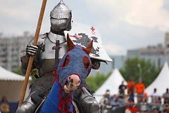 Medieval knight on horse in heavy protection