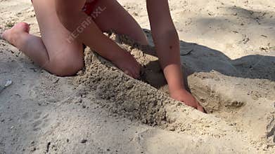 Little boy playing with sand on beach ocean sea. Child building sand castle house. Family summer holidays and trips to