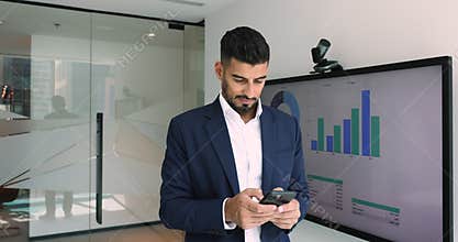 Indian financial analyst, CEO or company boss using smartphone