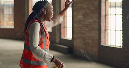 Confident Black Woman Engineer Dancing at Urban Construction Site