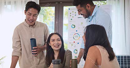 Young group of Asian businesspeople casual talk together. People holding tumbler, relax laugh and smile at home office
