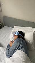 Young woman sleeping in bed