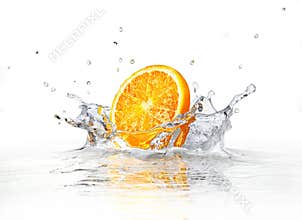 Orange slice falling and splashing into clear water.