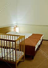 Hotel room with baby cot