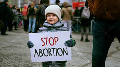 Little boy hold stop abortion banner pro life protest. Ban placard demonstration