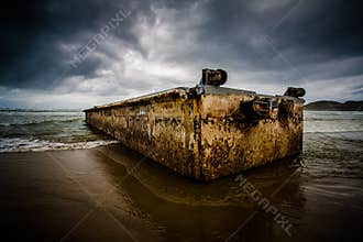 Dirty concrete box washed ashore