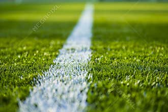 Green synthetic artificial grass soccer sports field with white stripe line. Soccer, rugby, football, baseball sport background,