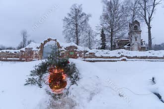 Christmas nook in a snow with ruins of church