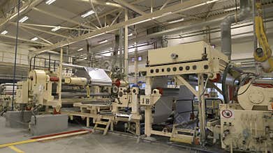 Paper roll machine with technicians in plant workshop