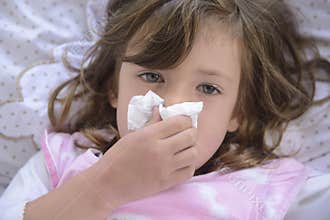 Sneezing child in bed