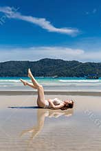 A young women sleeping on a sandy beaches during summer