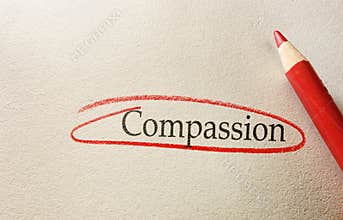 Compassion text circled in red pencil on textured paper background