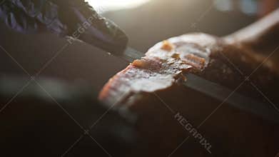 Chef cutting Jamon.