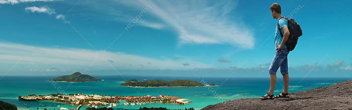 Tourist enjoying top mountain view of paradise islands. Panorama