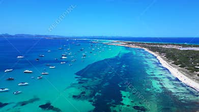 Formentera coastline, boats in tranquil turquoise sea. Perfect aerial view drone