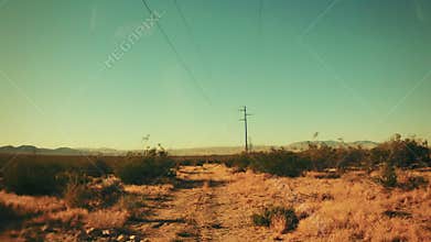 Driving on a Dirt Road in the Hot Desert
