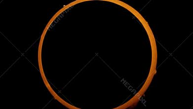 Annular solar eclipse isolated on black background rotating.