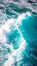 Turquoise ocean waves crashing with foamy white crests, aerial view
