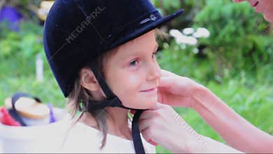 Child with a riding helmet