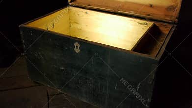 Old wooden treasure chest with strong glow from inside