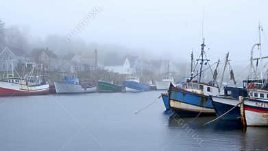 Serene Harbor In Fog. Silent Harbor With Vibrant Vessels Surrounded By Fog And Peaceful Reflections