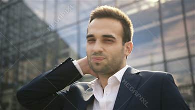 Portrait of businessman standing in front of modern building