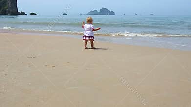 Girl in Ukrainian costume embroidery on beach