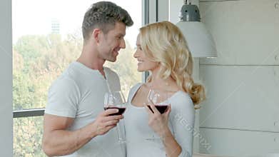 Happy Couple Drinking Red Wine To Celebrate