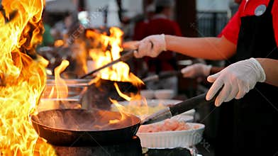 Professional Chef in a Commercial Kitchen Cooking Flambe Style