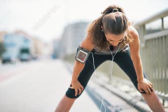 Tired fitness young woman catching breathe
