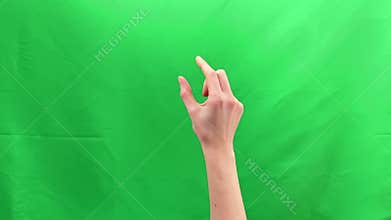 Two fingers performing pinch zoom gesture on green chroma background