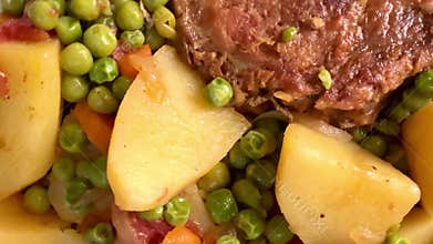Pork chop with peas and potatoes.