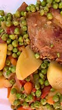 Pork chop with peas and potatoes.