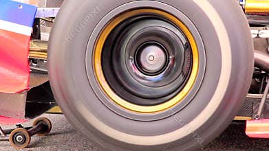 Formula one car wheel spinning while driver tests engine