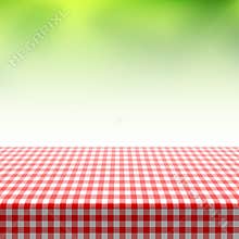Picnic table covered with checkered tablecloth