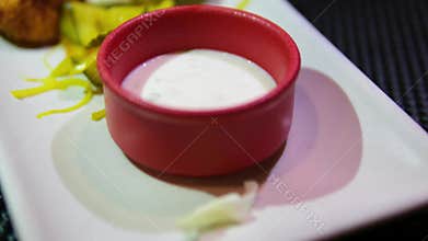 cauliflower in batter frying pan with pieces of cauliflower in batter of beaten eggs frying on it. cauliflower is fried