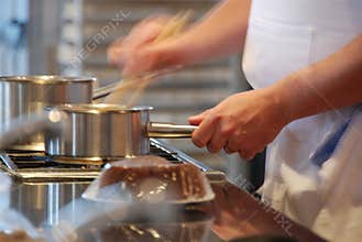 Busy chef at restaurant stove