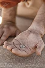 Beggar hand with coin