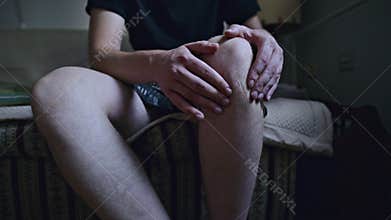 Person Massaging an Aching Knee Due to Joint Pain and Discomfort