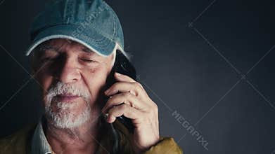 Old Man With a Hat is Talking to Cellphone