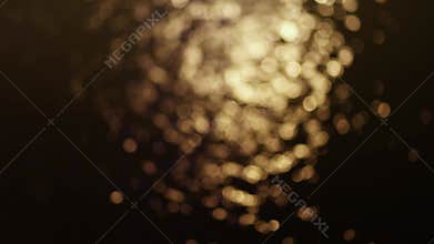 Golden bokeh shimmering on water surface at night, creating a warm and romantic atmosphere, calm emotional scenes, Perfect for