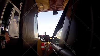 Highway driver pays road toll Booth