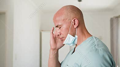 Stressed Healthcare Professional Experiences Burnout After Long Hours Wearing a Mask in a Hospital Setting