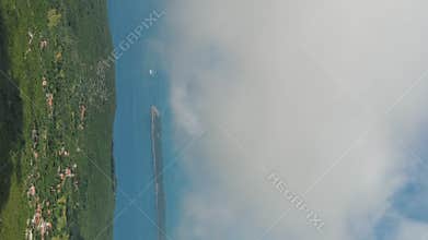 Flying through white clouds over sea