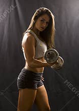 Strong Woman doing biceps curl with dumbbell