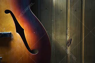 Details of an old jazz guitar on a wooden wall