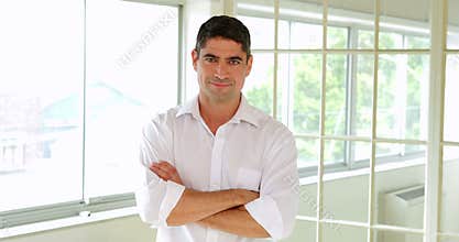 Handsome man posing with arms crossed