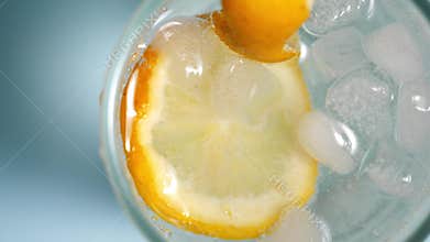Lemonade with lemon slices and ice in a glass