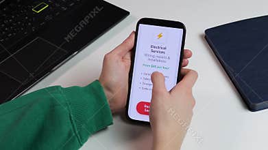 Close-up of a user booking professional electrical services via a mobile app. Features emergency repairs and certified